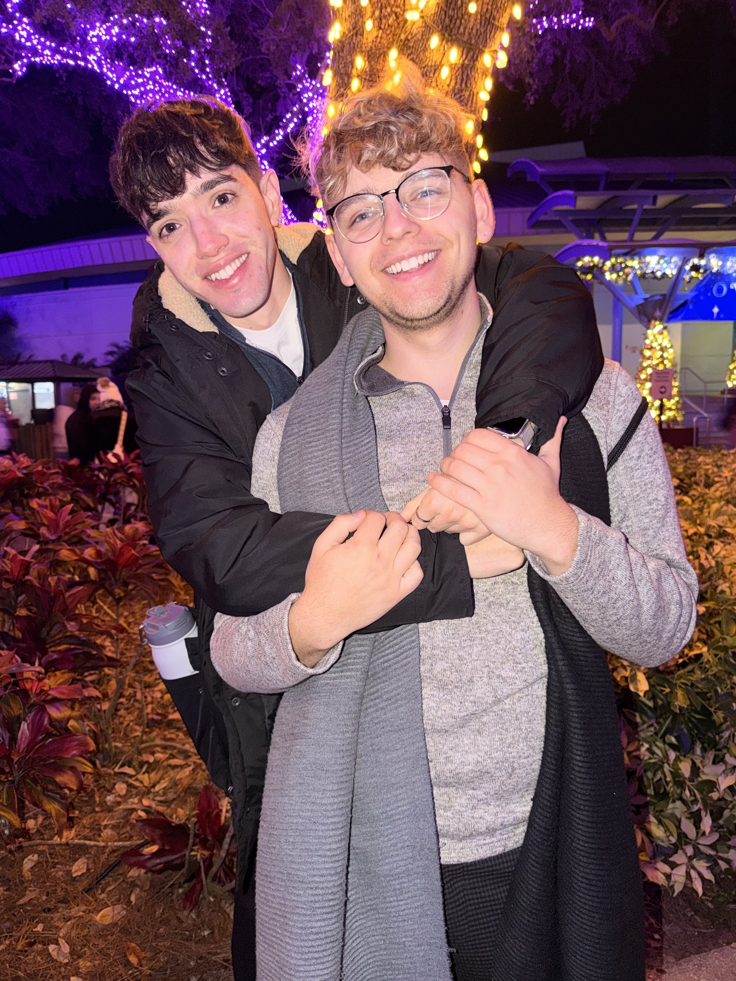 Dressed up together at a Christmas lights event, holding each other